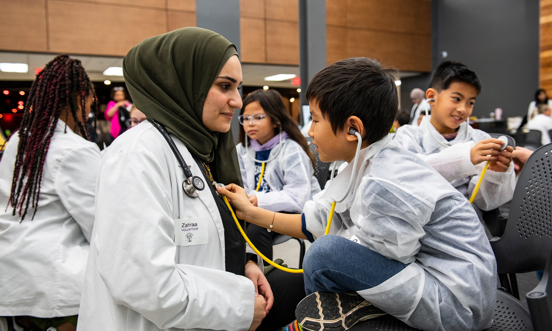 An image of an OUWB student and a Reach Out to Youth participant